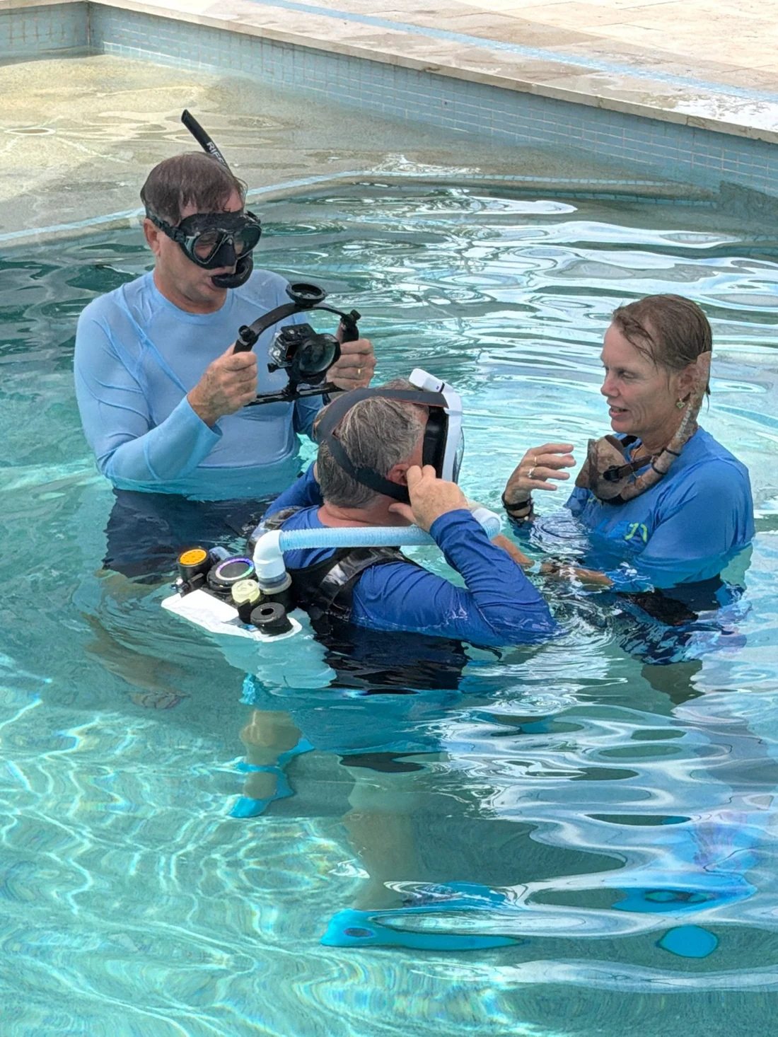 Test team fitting a mask on a diver at the surface